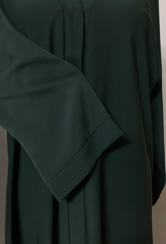 Close-up of the tailored sleeve on the emerald green Zoya fabric abaya.