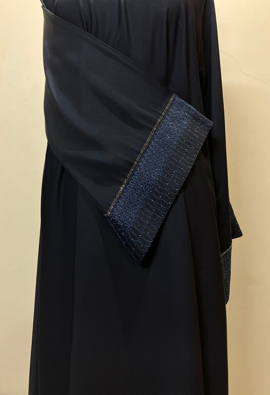 Close-up of the unique design on the sleeves of the Sultanah navy abaya, showcasing the intricate stitching and craftsmanship.
