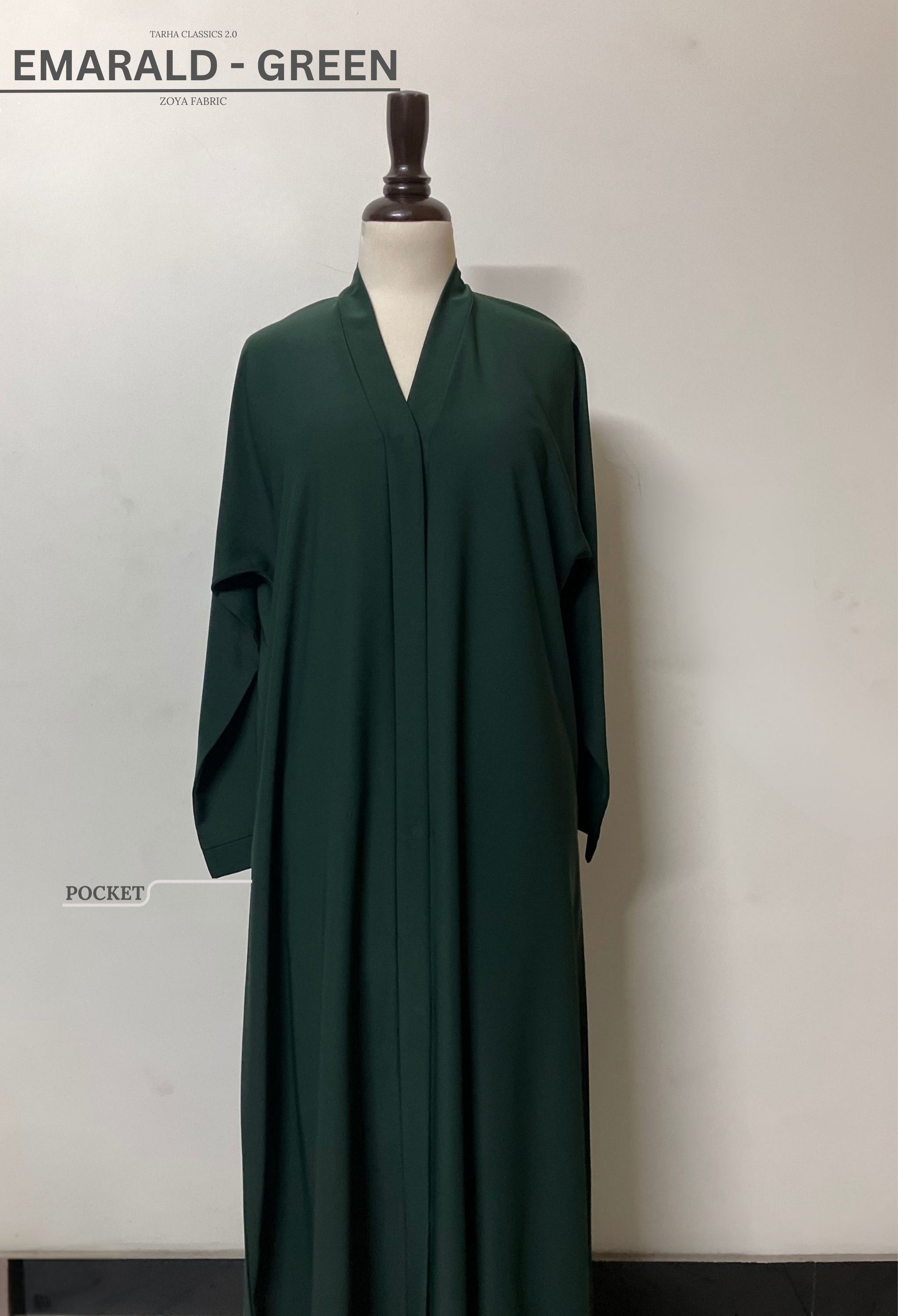 Emerald green abaya in premium Zoya fabric featuring a functional side pocket and a clean, minimalist front – Tarha.pk Classics V2.

