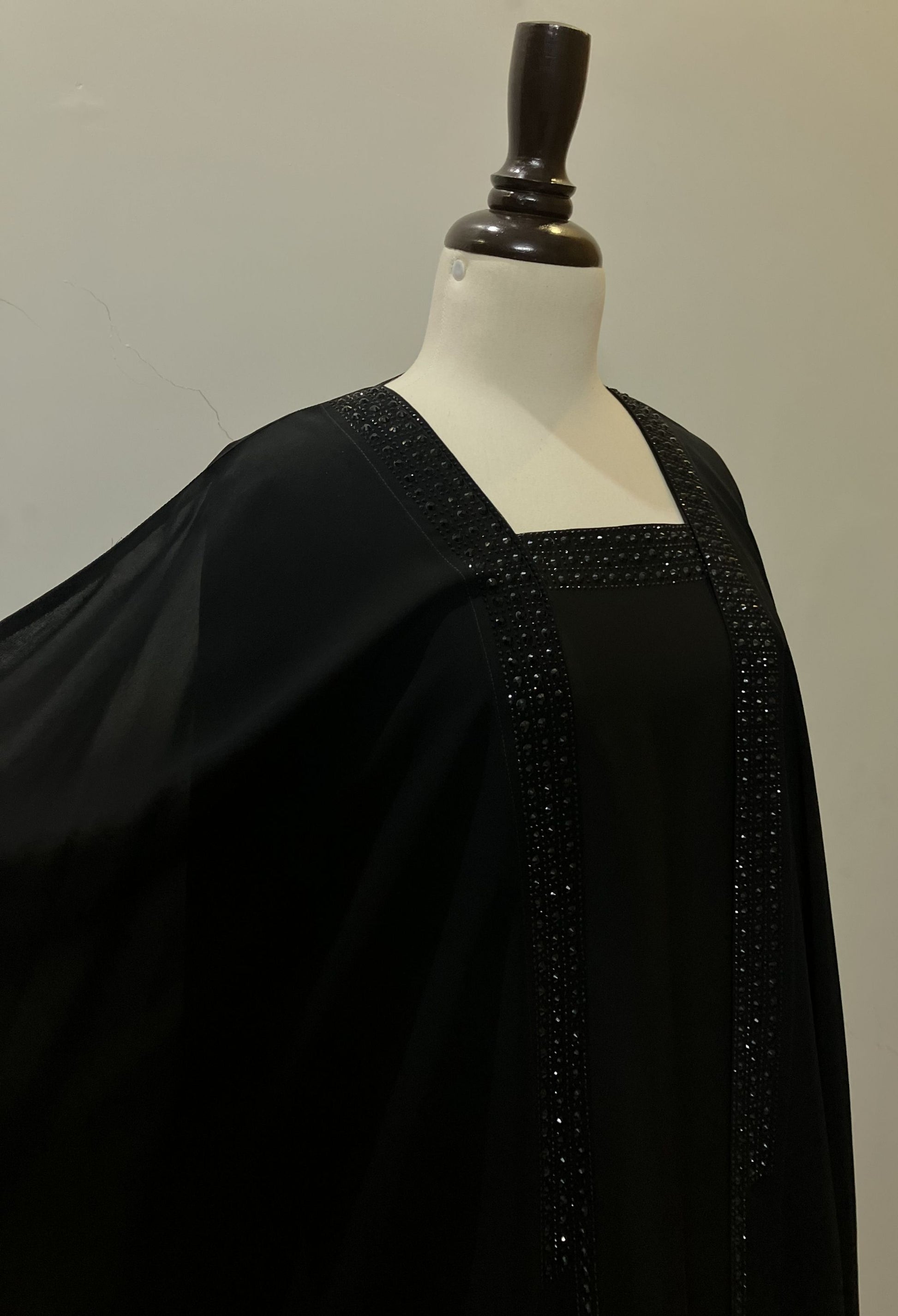 Detailed view of the modest round neckline and high-quality stitching on the Imperial black double-layer kaftan.