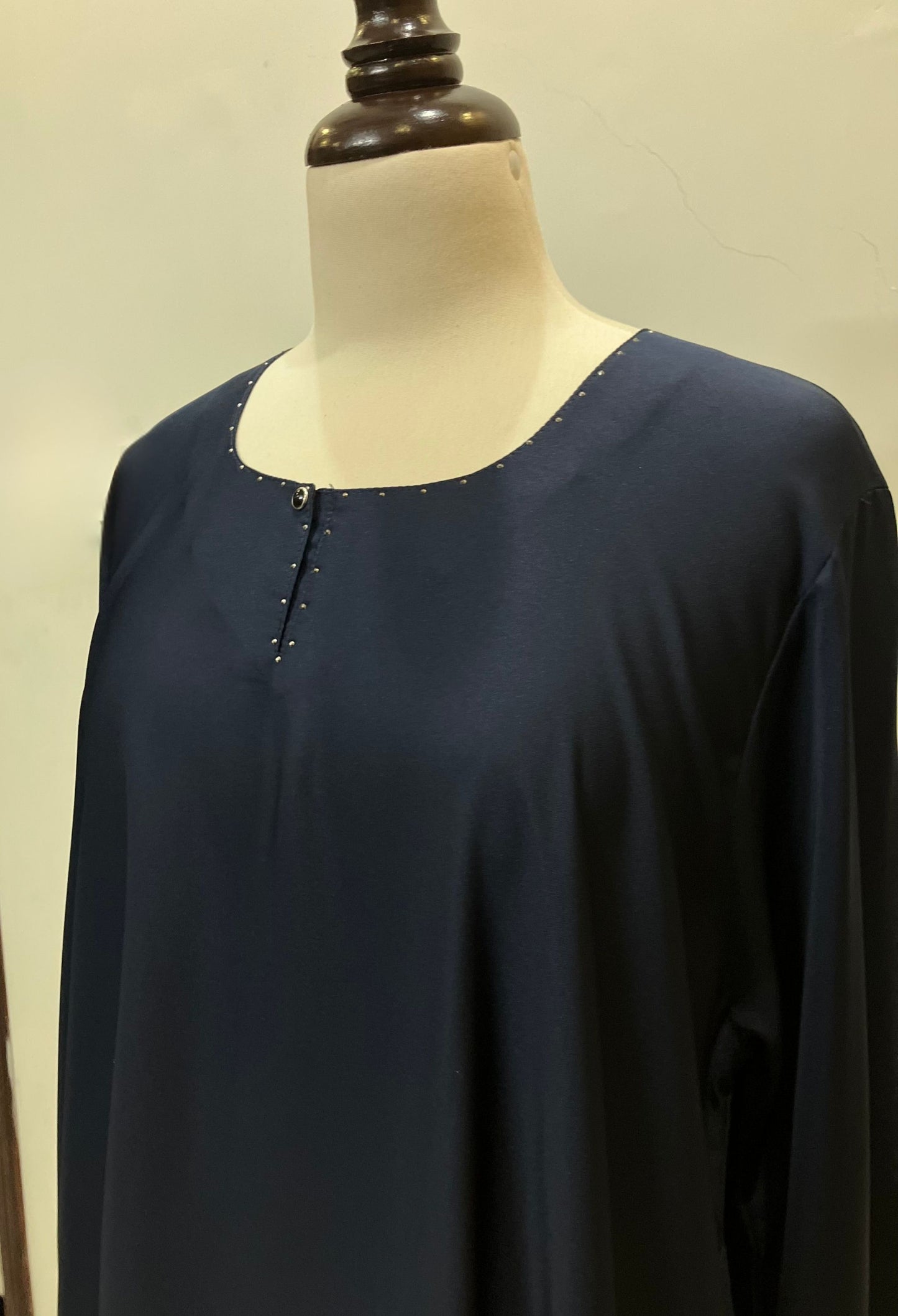 Detailed view of the modest neckline and shoulder construction of the Sultanah navy blue abaya.