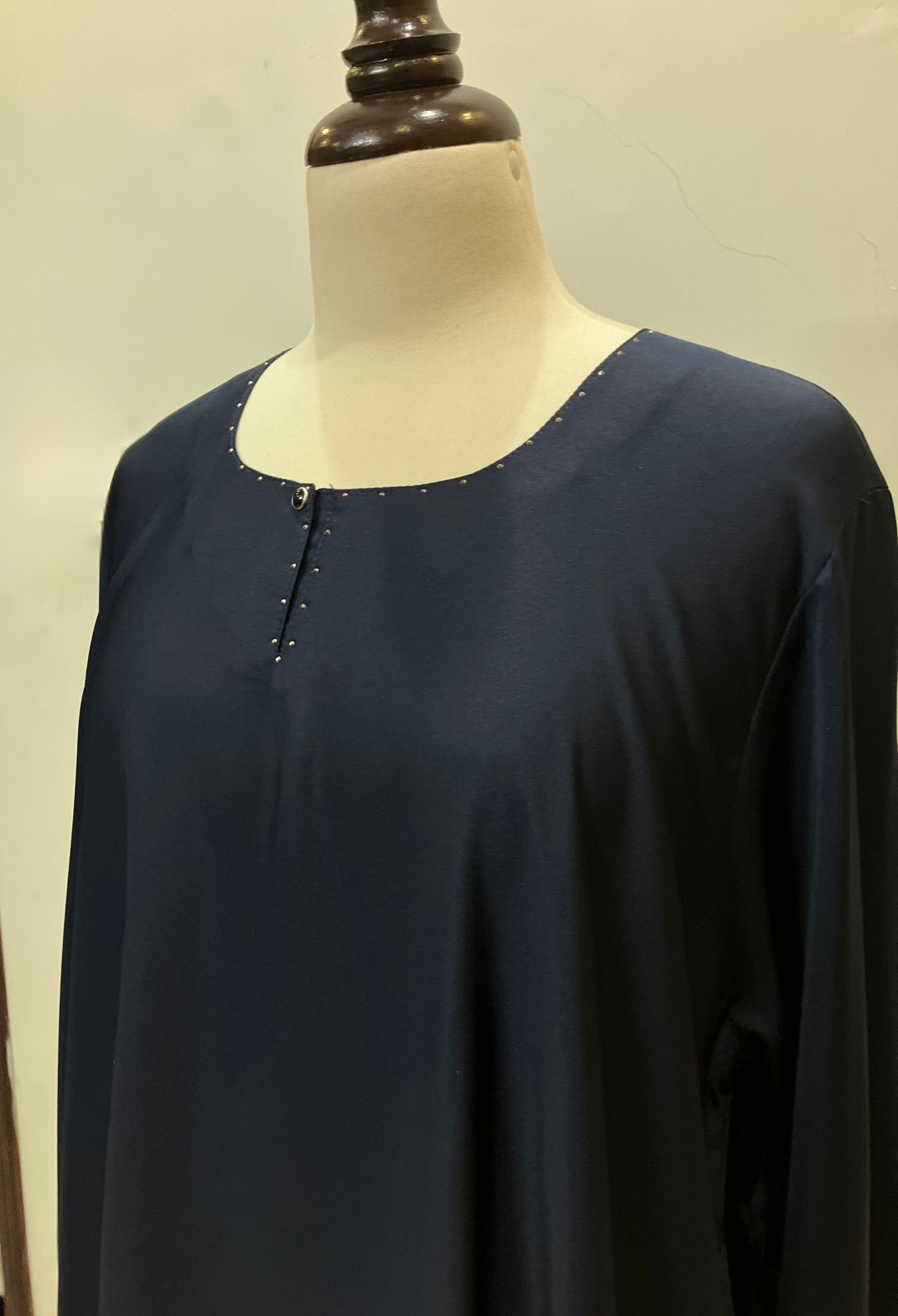 Detailed view of the modest neckline and shoulder construction of the Sultanah navy blue abaya.