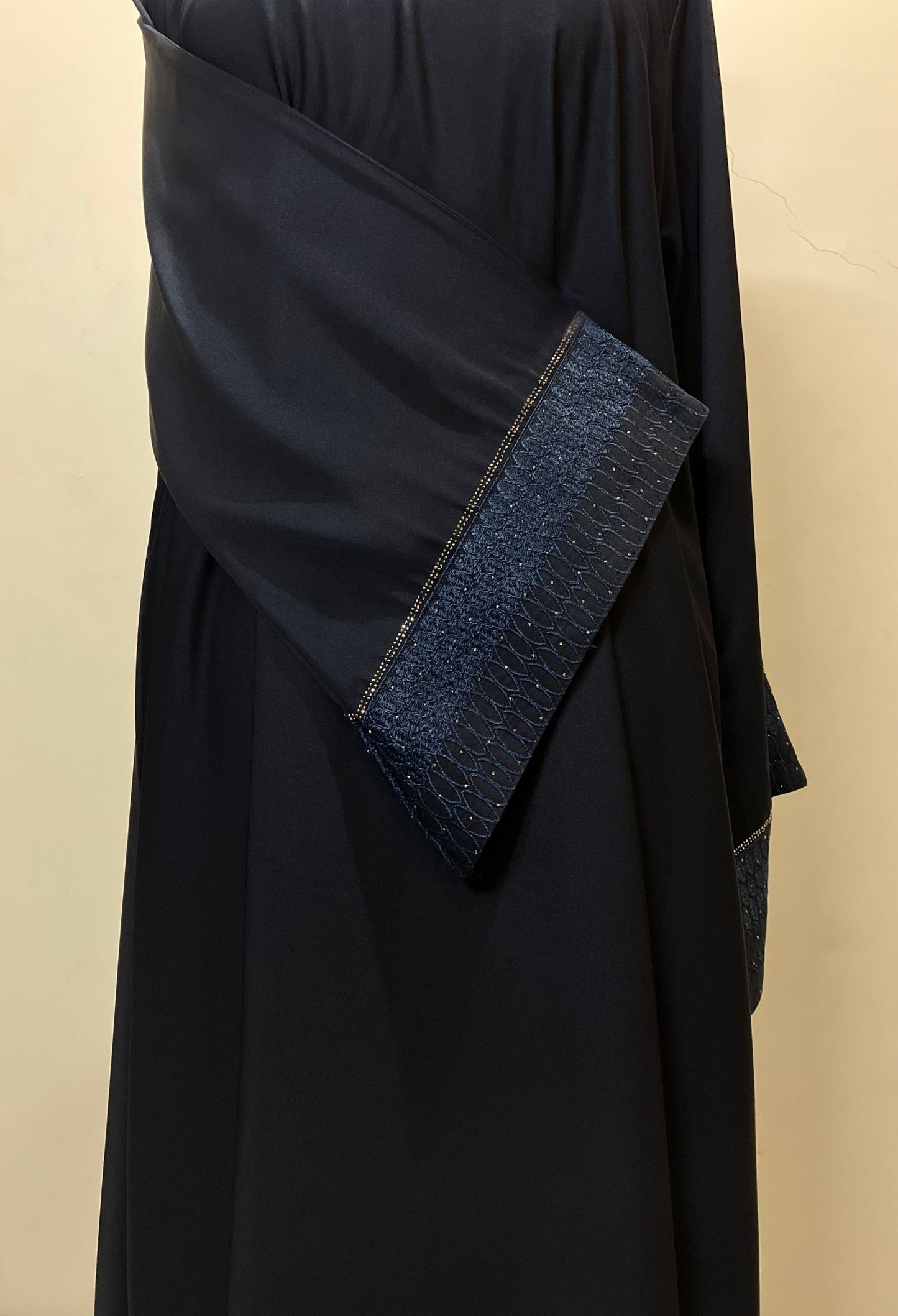 Close-up of the unique design on the sleeves of the Sultanah navy abaya, showcasing the intricate stitching and craftsmanship.