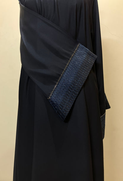 Close-up of the unique design on the sleeves of the Sultanah navy abaya, showcasing the intricate stitching and craftsmanship.