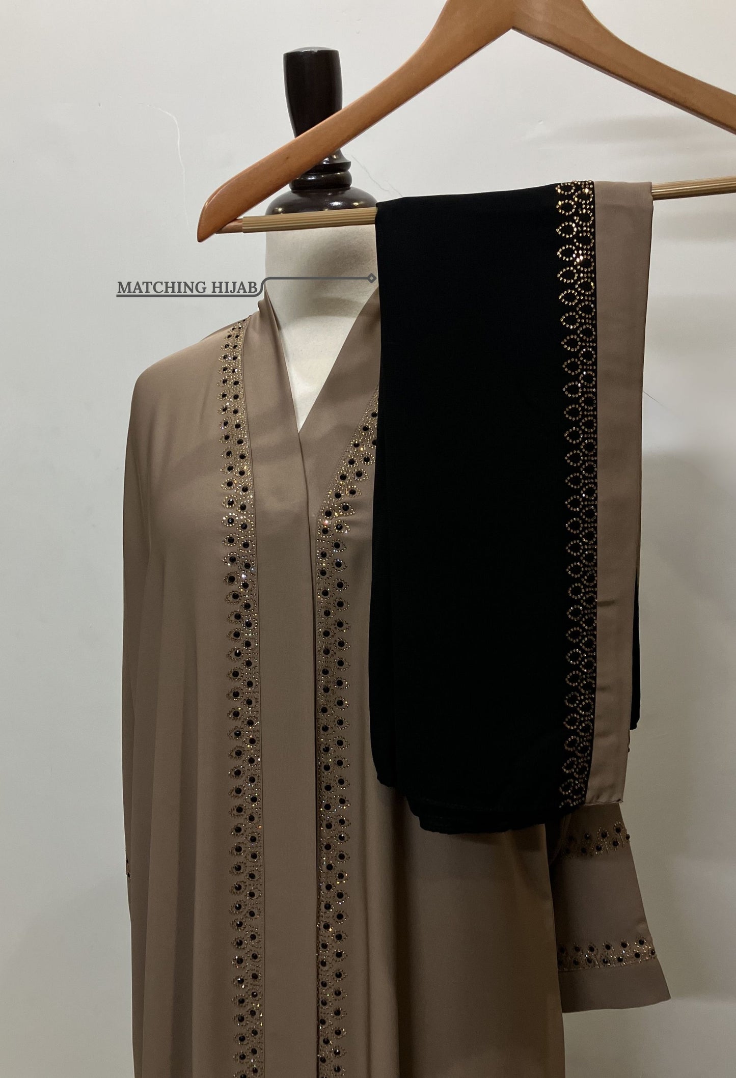 Zahra golden abaya set featuring a free matching Nida hijab with a decorative golden border.
