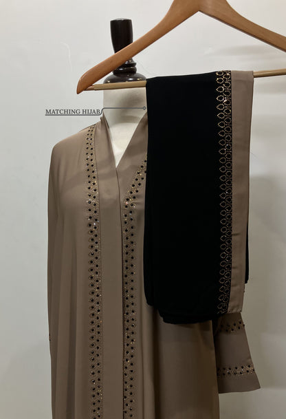 Zahra golden abaya set featuring a free matching Nida hijab with a decorative golden border.
